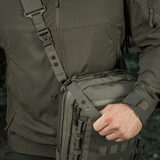 Person carrying M-Tac Tablet Bag Laser Cut Hex with MOLLE panel, ideal for EDC, hidden weapon, documents, and tablets.