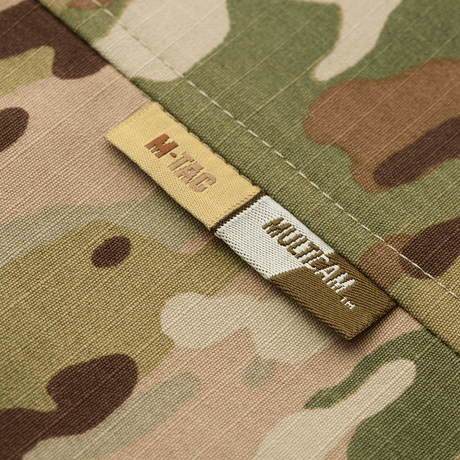 M-Tac Jakke Military Elite NYCO med MultiCam-design, fokus på mærker og rip-stop stof til holdbarhed og stil.