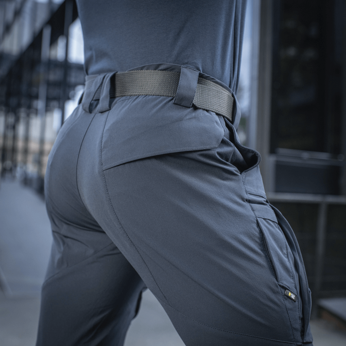 Person wearing M-Tac Bukser Rubicon Flex with cargo pockets and stretch fabric, ideal for outdoor activities.