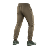 Man wearing M-Tac Bukser Stealth Cotton from behind, showcasing elastic waistband and pocket design. Perfect for sports and everyday wear.