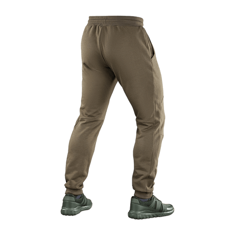 Man wearing M-Tac Bukser Stealth Cotton from behind, showcasing elastic waistband and pocket design. Perfect for sports and everyday wear.