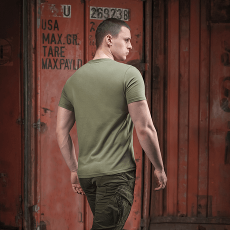 Mand i M-Tac T-shirt Viking foran container, set bagfra, militærgrøn stil