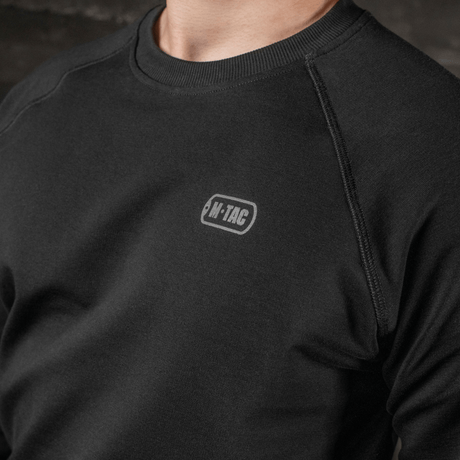 M-Tac Raglan Athlete sweatshirt sort med rund hals og raglanærmer, ideel til sport og daglig brug, viser M-Tac logo.