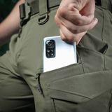 Person iklædt M-Tac Aggressor Summer Flex Shorts viser komfortable sidelommer med D-ring til udstyrafhæftelse, praktisk til mobiltelefon.