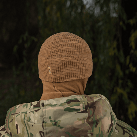 M-Tac Rip-Stop Fleece Hjelmliner i naturmiljø med camouflagejakke, ideel til koldt vejr.
