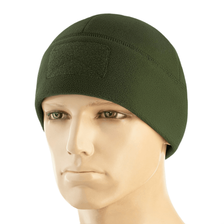 M-Tac Watch Cap Elite Fleece Beanie Hat Velcro i grøn, let og varm hue til taktisk brug med velcro-panel til mærker, bæres på mannequin.