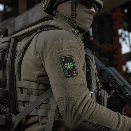 Soldat med M-Tac Patch Kort Helm of Horror (Broderi) fastgjort til jakke, broderet med ægishjálmur symbol, Cordura 500D materiale.