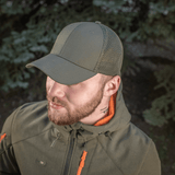 Mand iført M-Tac Mesh Flex Ripstop Baseball Cap med mesh-paneler til ventilation udendørs i naturmiljø.
